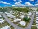 Aerial view of a mobile home community with lush landscaping at 6405 Kilohee Ct, North Port, FL 34287