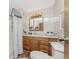 Bathroom features a wood vanity, shower, and toilet at 6405 Kilohee Ct, North Port, FL 34287