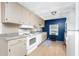 Kitchen features white appliances and beige cabinetry at 6405 Kilohee Ct, North Port, FL 34287