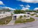 Aerial view of a manufactured home in a community setting with palm trees and landscaping at 6405 Kilohee Ct, North Port, FL 34287