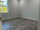 Bright bedroom with wood-look flooring and neutral walls at 1259 Kaayan St, North Port, FL 34288