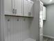 Bright laundry room with white cabinets and built-in bench at 1259 Kaayan St, North Port, FL 34288