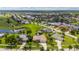 Beautiful aerial view of a home with lush landscaping, a serene lake and golf course community at 437 Madrid Blvd, Punta Gorda, FL 33950