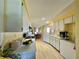 Galley kitchen with white cabinets and light wood floors at 1629 Birchcrest Blvd, Port Charlotte, FL 33952