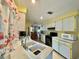 Bright kitchen features double sink, microwave, and ample cabinetry at 1629 Birchcrest Blvd, Port Charlotte, FL 33952