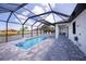 Resort-style pool with screened enclosure and patio at 11 Pinehurst Ct, Rotonda West, FL 33947