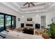 Spacious living area with a cozy fireplace, stylish built-ins, and plenty of natural light at 11 Pinehurst Ct, Rotonda West, FL 33947