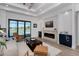 Relaxing living space featuring a modern fireplace and sliding doors leading to the pool area at 11 Pinehurst Ct, Rotonda West, FL 33947