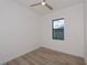 Bright bedroom with wood-look floors and ceiling fan at 11 Pinehurst Ct, Rotonda West, FL 33947