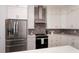 Modern kitchen with stainless steel appliances and white cabinets at 11 Pinehurst Ct, Rotonda West, FL 33947