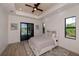 Spacious main bedroom featuring a ceiling fan and access to a private patio at 11 Pinehurst Ct, Rotonda West, FL 33947