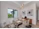 A dining room with a wooden table, six chairs, and a view of the outdoors at 11 Pinehurst Ct, Rotonda West, FL 33947
