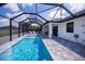 Screened pool and patio with lounge chairs at 11 Pinehurst Ct, Rotonda West, FL 33947