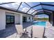 Relaxing pool area with covered lanai and lounge chairs at 11 Pinehurst Ct, Rotonda West, FL 33947