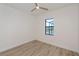 Light bedroom with wood-look floors and window overlooking pool at 11 Pinehurst Ct, Rotonda West, FL 33947