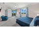 Main bedroom with blue bedding and access to a private balcony at 15999 Grassland Ln # 3221, Punta Gorda, FL 33982