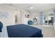 Main bedroom with blue bedding and access to a balcony at 15999 Grassland Ln # 3221, Punta Gorda, FL 33982