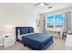Bedroom with a blue bed, window, and built-in desk at 15999 Grassland Ln # 3221, Punta Gorda, FL 33982