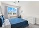 Bedroom with blue bed, window, and built-in desk at 15999 Grassland Ln # 3221, Punta Gorda, FL 33982