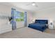Spacious bedroom with a plush blue bed and large window at 15999 Grassland Ln # 3221, Punta Gorda, FL 33982