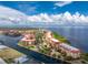 Aerial view of waterfront condo building with private parking and tropical landscaping at 85 Vivante Blvd # 8534, Punta Gorda, FL 33950