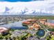 Aerial view of resort-style community with tennis courts, pool, and waterfront access at 85 Vivante Blvd # 8534, Punta Gorda, FL 33950
