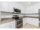 Modern kitchen featuring stainless steel appliances and granite countertops at 85 Vivante Blvd # 8534, Punta Gorda, FL 33950