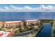 Aerial view of waterfront condo building with lush landscaping and private parking at 85 Vivante Blvd # 8534, Punta Gorda, FL 33950