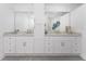 Double vanity bathroom with granite countertops and white cabinets at 85 Vivante Blvd # 8534, Punta Gorda, FL 33950