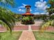 Gated community entrance with lush landscaping and a guardhouse at 85 Vivante Blvd # 8534, Punta Gorda, FL 33950