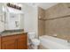 Bathroom with granite vanity, tub, and tile surround at 85 Vivante Blvd # 8534, Punta Gorda, FL 33950