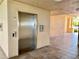 Stainless steel elevator in well-lit building hallway at 85 Vivante Blvd # 8534, Punta Gorda, FL 33950