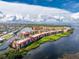 Aerial view of waterfront condo building with lush landscaping and water access at 85 Vivante Blvd # 8534, Punta Gorda, FL 33950