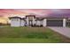 Modern single-story home with attached garage and attractive landscaping at 10429 New Brittain St, Port Charlotte, FL 33981