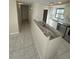 View of kitchen island and hallway leading to other rooms at 3230 White Ibis Ct # A1-2, Punta Gorda, FL 33950