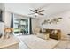 Bright living room with comfy seating and sliding glass doors leading to a patio at 6516 Serenity Fall Ln, Sarasota, FL 34240