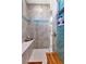 Spa-like shower with dual shower heads, built-in shelving, and tiled walls at 9978 Audrey St, Port Charlotte, FL 33981
