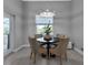 Casual dining area with round table and four chairs near a sliding glass door at 9978 Audrey St, Port Charlotte, FL 33981