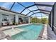 Lush backyard with a screened pool area at 9978 Audrey St, Port Charlotte, FL 33981