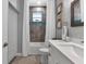 Updated bathroom featuring a white vanity, grey tile, and a tub shower at 9978 Audrey St, Port Charlotte, FL 33981