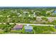 Aerial view of two houses with pools in a quiet residential neighborhood at 9978 Audrey St, Port Charlotte, FL 33981