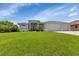 Two-story house with three-car garage and well-manicured lawn at 9978 Audrey St, Port Charlotte, FL 33981