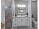 Modern bathroom with white vanity, gray tile, and a toilet at 9978 Audrey St, Port Charlotte, FL 33981