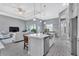 Open concept kitchen with island, stainless steel appliances, and white cabinetry at 9978 Audrey St, Port Charlotte, FL 33981