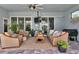 Outdoor living space with seating, fan and grill at 9978 Audrey St, Port Charlotte, FL 33981