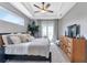 Relaxing main bedroom with wood dresser and large TV at 9978 Audrey St, Port Charlotte, FL 33981