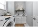 Modern laundry room, featuring Whirlpool appliances at 9978 Audrey St, Port Charlotte, FL 33981