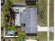 An aerial view of the home's roof, backyard patio, and side yard with well-established landscaping at 22062 Marshall Ave, Port Charlotte, FL 33952