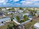 Aerial view of a single-Gathering home featuring a fenced backyard with lush greenery and a pool at 22062 Marshall Ave, Port Charlotte, FL 33952