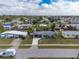 Overhead shot of the property showcasing its location in a residential neighborhood with mature trees and landscaping at 22062 Marshall Ave, Port Charlotte, FL 33952